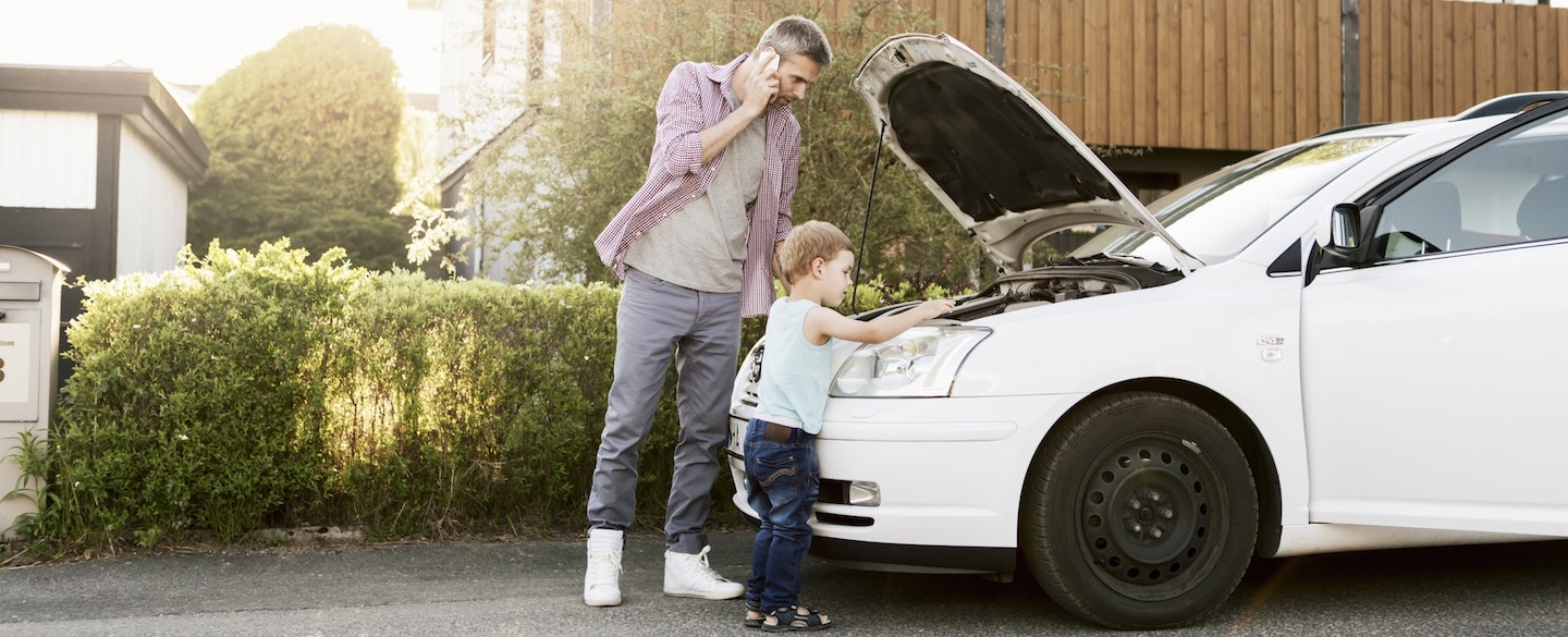 Father and son working on their car