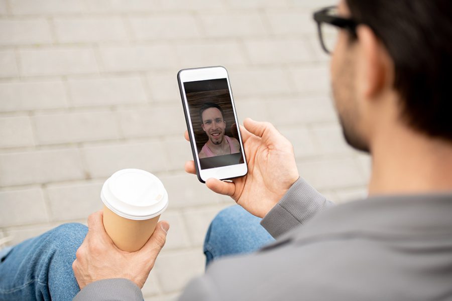 a man video conferencing with his phone.