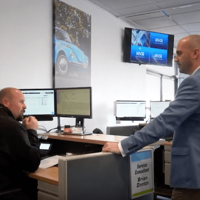 Two auto technicians in a conversation.