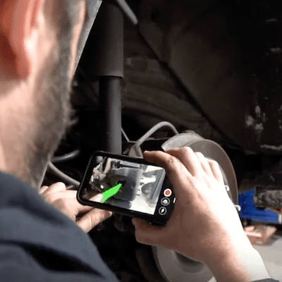 a mechanic takes a video using TruVideo.