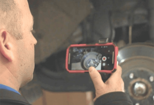 a service technician uses TruVideo to take a video of a repair.